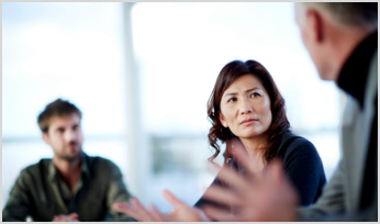 3 people collaborating together in a conference room