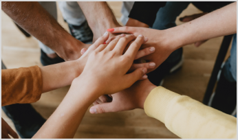 bunch of human hands on top of each other