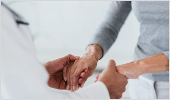 a doctor holding a patient's hands